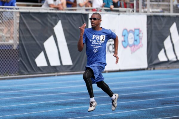 man blue shirt running track